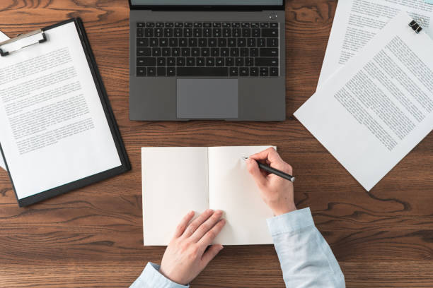 istock Woman working behind wooden table in office 1163803827