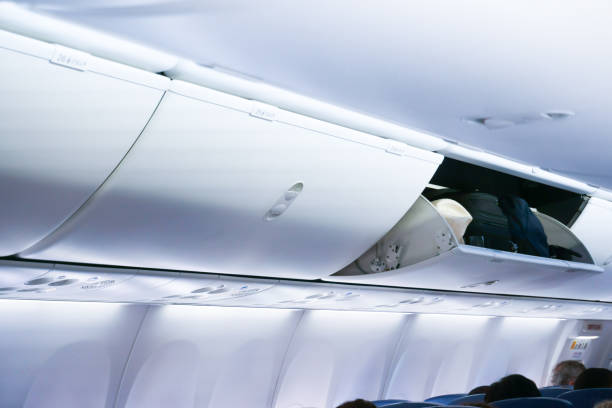 istock Airplane cabine with the luggage compartments 1163804512