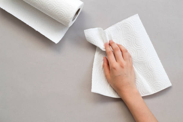 istock Woman wiping table with paper towel 1163806654