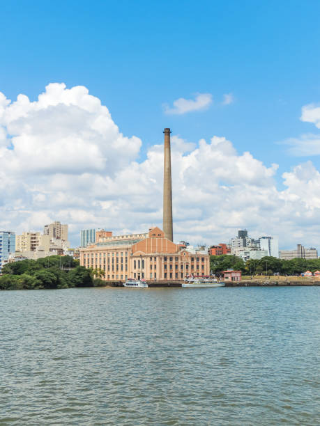 A view of the landmark of Usina do Gasômetro from the surface of the Guaíba river Porto Alegre, RS / Brazil - 02/12/2013: A view of the landmark of Usina do Gasômetro from the surface of the Guaíba river with a blue sky and some cumulus clouds porto alegre stock pictures, royalty-free photos & images