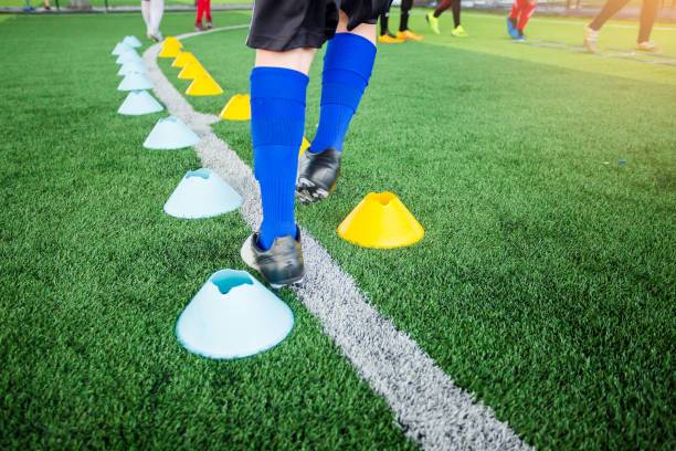 istock Kid soccer player moving speed test and Jogging and jump between marker 1163810179