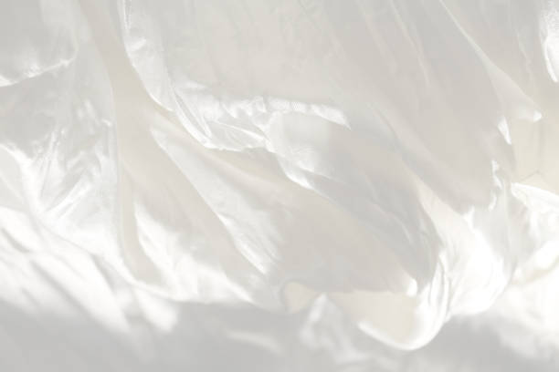 istock Very gentle delicate beautiful elegant light white blur background - natural matte and shiny silk in drapery, folds, wrinkles for wedding cards, exquisite solemn backgrounds 1163812706