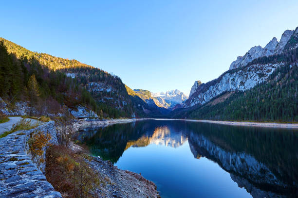 istock Beautiful Gosausee lake landscape with Dachstein mountains, forest, clouds and reflections in the water in Austrian Alps. Salzkammergut region. 1163815053