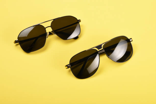 istock Sunglasses on the yellow background 1163818559