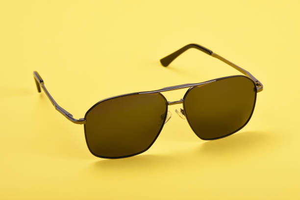 istock Sunglasses on the yellow background 1163818762