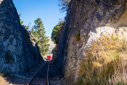 A locomotive takes tourists along the Weka Pass Railway through scenic limestone outcrops and past vineyards from Waipara to Waikari in Canterbury, New Zealand