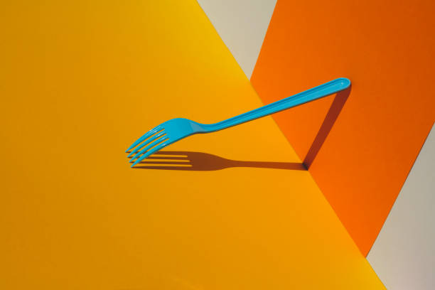 istock Close-up of fork on yellow background 1163821426