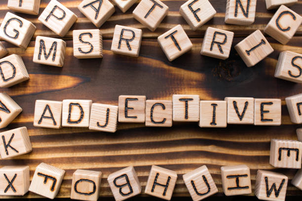 istock word adjective composed of wooden cubes with letters 1163824555