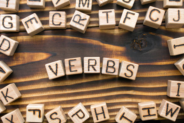 istock word verbs composed of wooden cubes with letters 1163824557