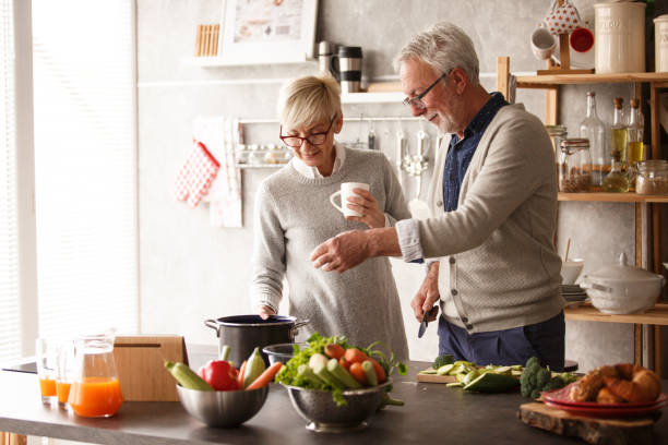 istock Happy senior couple preparing lunch together 1163827868