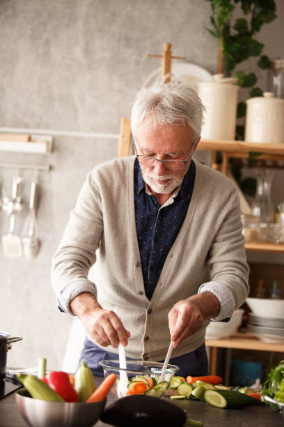 istock Senior man mixing a salad 1163827870
