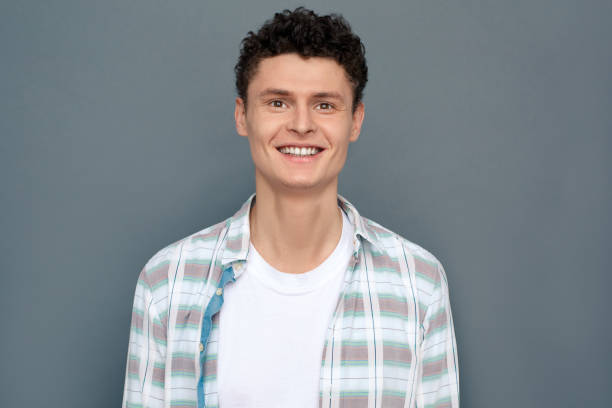 istock Man isolated on gray wall free style looking camera cheerful 1163828037