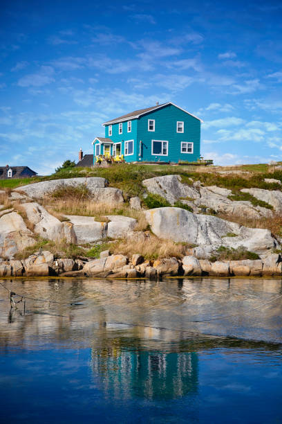 Colorful buildings and a beautiful lighthouse dot the coast of Peggy's Cove in Nova Scotia, Canada