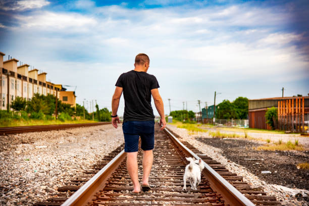 Man Walking His Dog on the Tracks