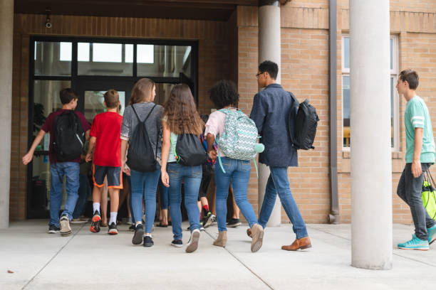 istock Elementary students walking in the main entrance to school 1163833357
