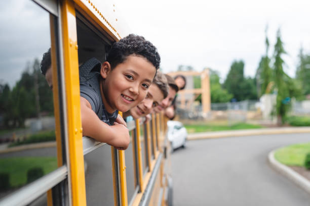 istock Portrait of elementary students in school bus 1163833358