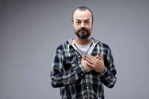 istock Sincere man crossing his hands over his heart 1163836923
