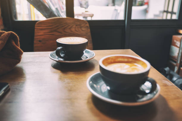 istock two blue cups of hot latte coffee on wooden table 1163841486