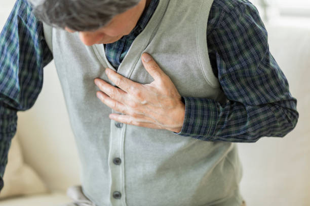 istock Senior man holding chest with hands 1163843451