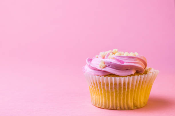 istock Festive cupcake with fruit on a pink background. 1163844378
