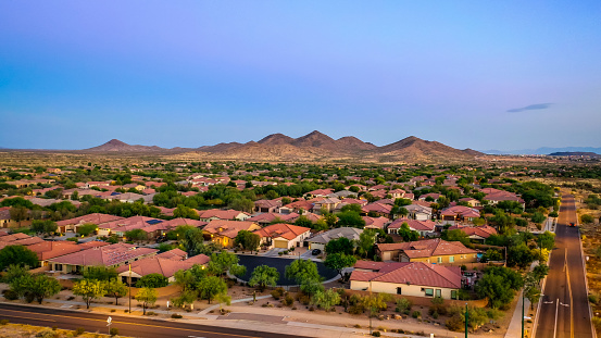 Aerial view of a desert community in Arizona during the golden hour at sunset.