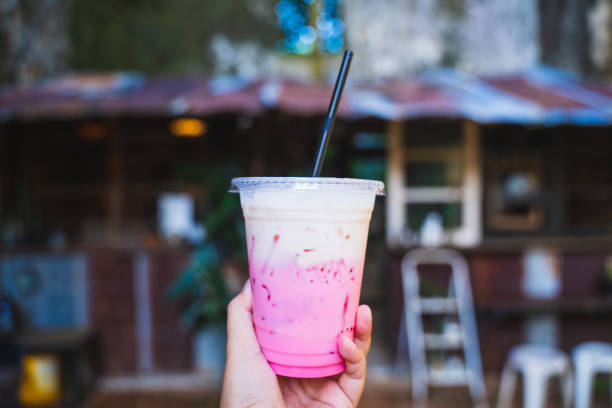 istock iced pink milk in plastic glass 1163846230
