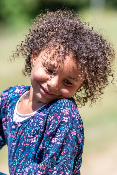 istock Smiling little girl looking down 1163850379