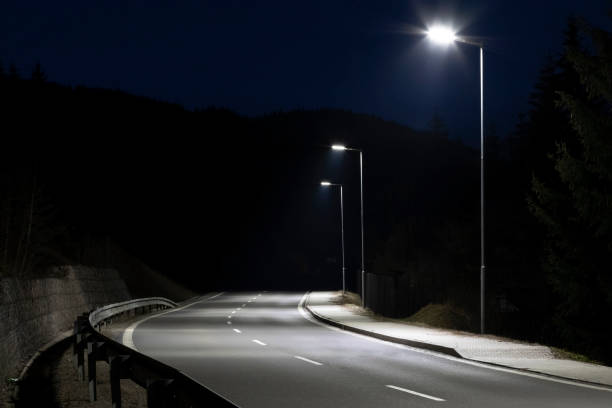 istock modern streetlights with LED technology at night, empty modern road 1163852307
