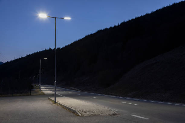 istock modern streetlights with LED technology at night, empty modern road 1163852390