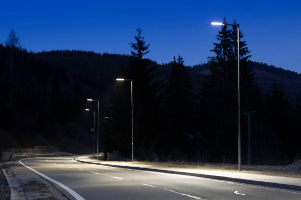istock modern streetlights with LED technology at night, empty modern road 1163852419