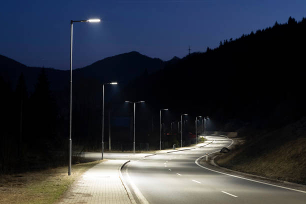 istock modern streetlights with LED technology at night, empty modern road 1163852466