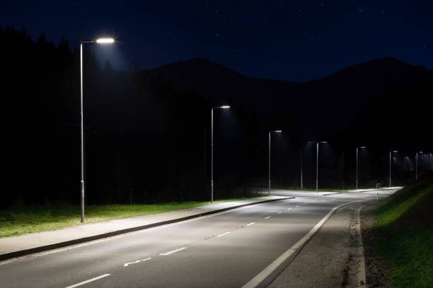istock modern streetlights with LED technology at night, empty modern road 1163852489