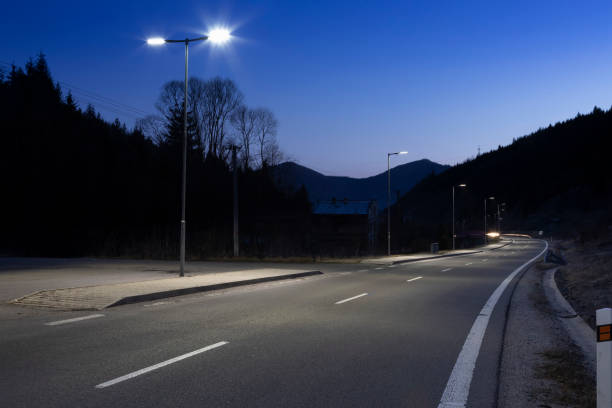 istock modern streetlights with LED technology at night, empty modern road 1163852538