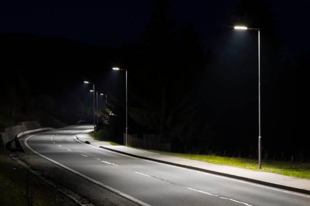 istock modern streetlights with LED technology at night, empty modern road 1163852714