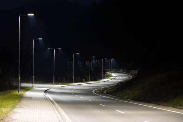 istock modern streetlights with LED technology at night, empty modern road 1163852806