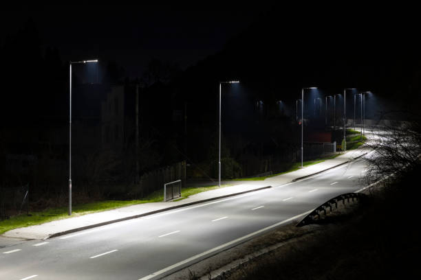 istock modern streetlights with LED technology at night, empty modern road 1163852855