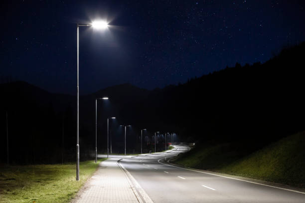istock modern streetlights with LED technology at night, empty modern road 1163853381