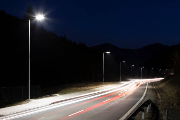 istock modern streetlights with LED technology at night, empty modern road 1163853388