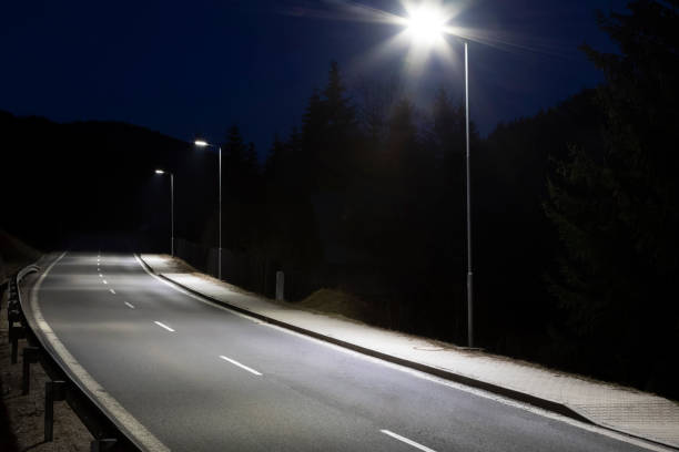 istock modern streetlights with LED technology at night, empty modern road 1163853403