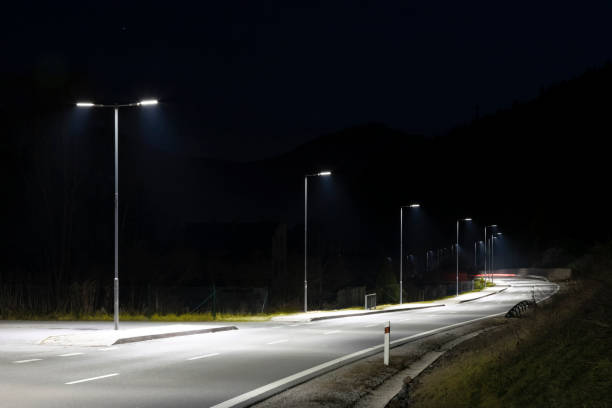 istock modern streetlights with LED technology at night, empty modern road 1163853421