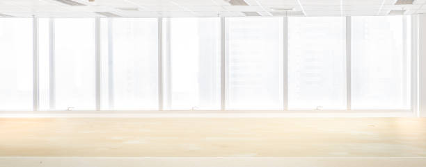 istock Empty wood table top with Blur inside office building with window background, interior and business background. 1163855469