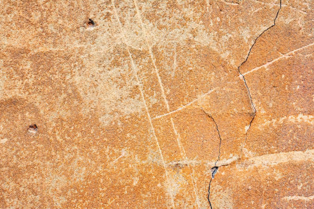istock Texture of a concrete wall with cracks and scratches which can be used as a background 1163856505