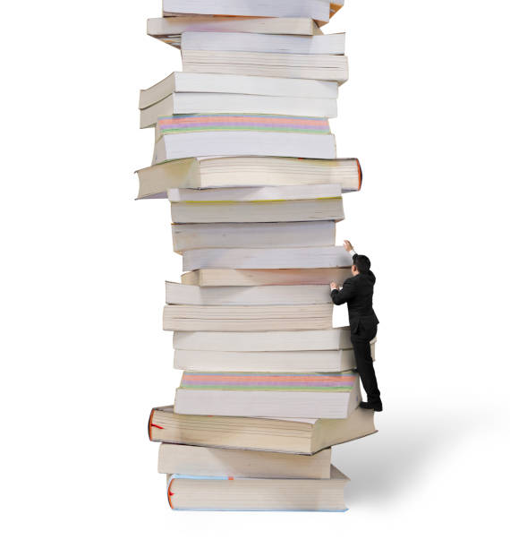 istock High stack of books with businessman climbing it 1163858420