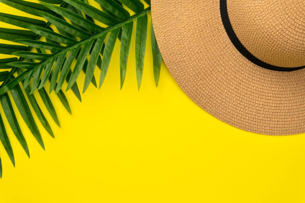 istock Flat Lay summer composition of Straw Hat with Tropical Palm Leaf on yellow background. Summer Vacation Concept with copy space. Top view 1163860008