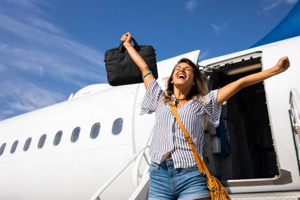 Yay, I have finally left the airplane! Cheerful woman celebrating getting out of the airplane. disembarking stock pictures, royalty-free photos & images