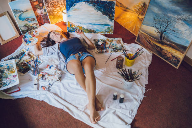 istock Woman painter surrounded with her art 1163865401