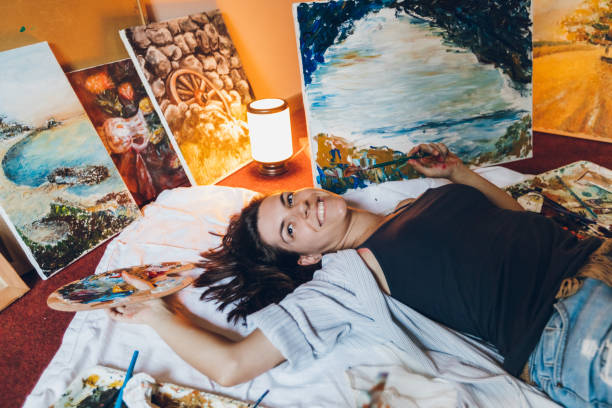 istock Woman painter surrounded with her art 1163865412