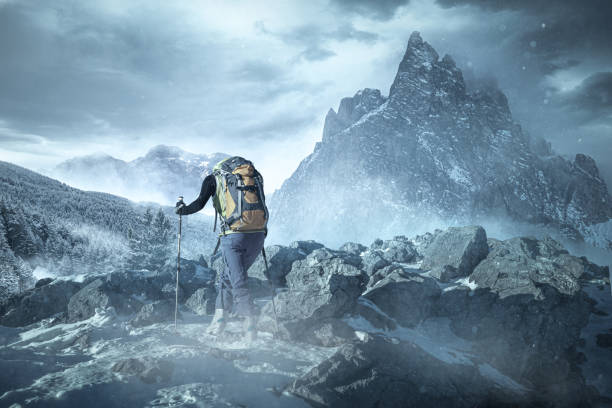 Hiker in mountainous winter landscape