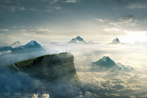 istock Hiker at sunrise on a mountain peak 1163867554