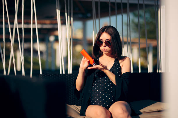 istock Cautious Pregnant Woman Using Sun Screen Lotion 1163867852